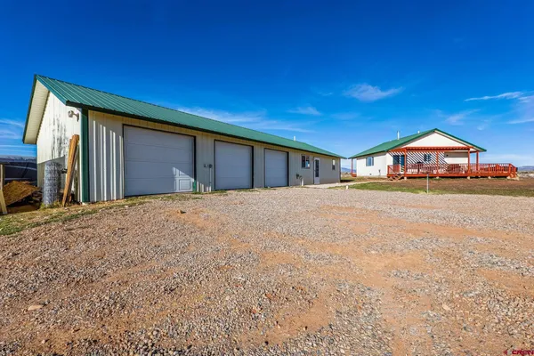 a view of a house with a yard and garage