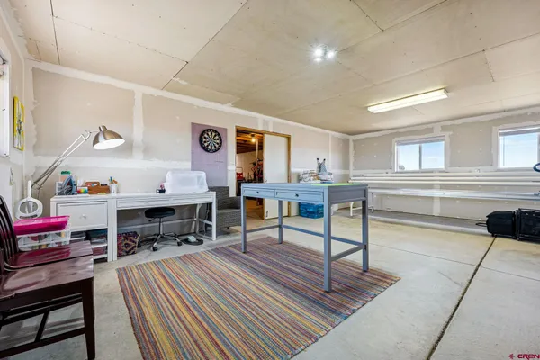a living room with furniture a rug and a piano