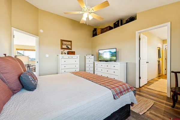 a bedroom with a bed and a flat tv screen on dresser