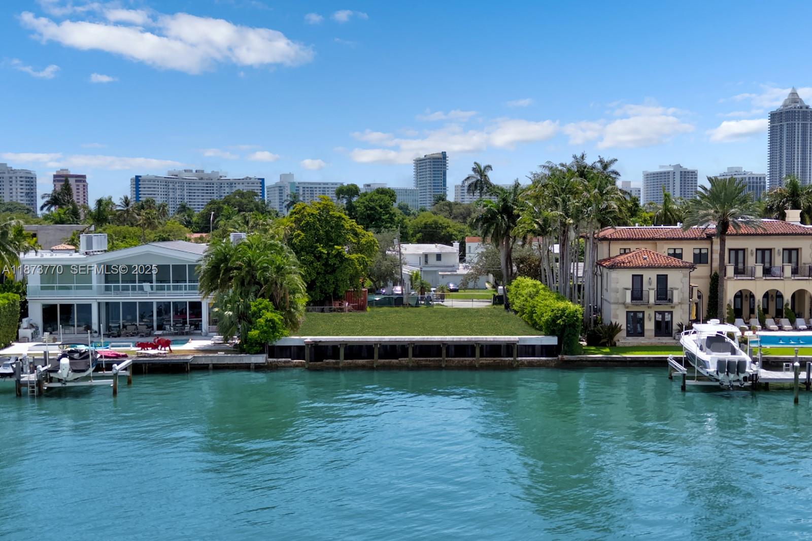 5226 North Bay Road Miami Beach, FL 33140 - Photo 9 of 13 a view of a lake with a residential building in the background