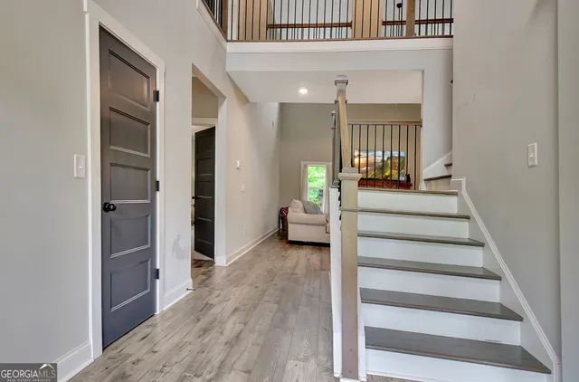 a view of a hallway with wooden floor and entryway