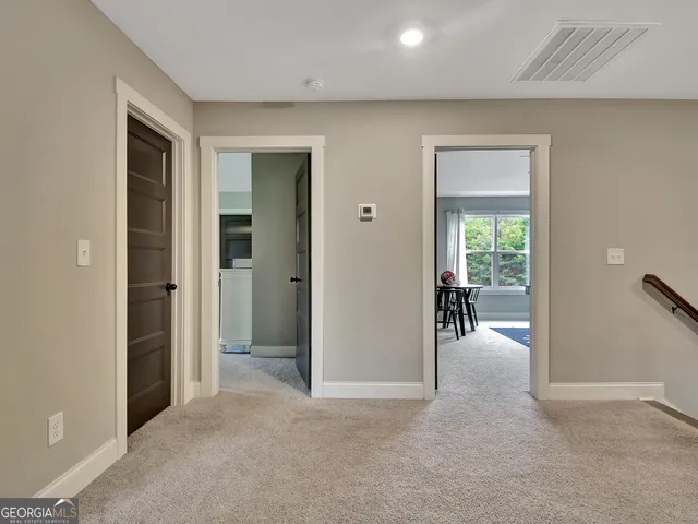 an empty room and a bathroom with mirror