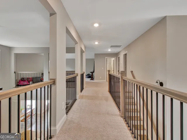 a living room with furniture a flat screen tv and a table