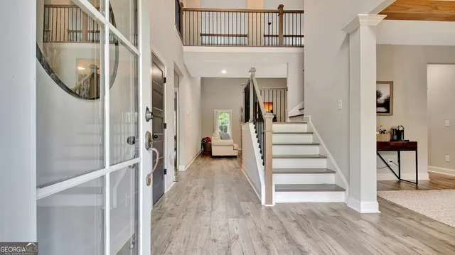 a view of a hallway with wooden floor and entryway