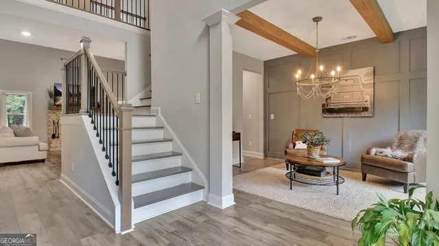 a view of a livingroom with furniture and stairs