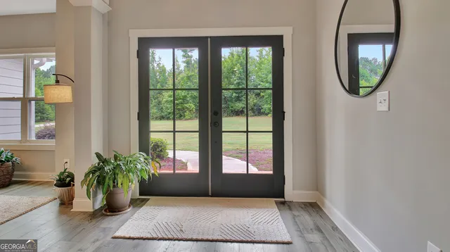an entryway with wooden floor mirror