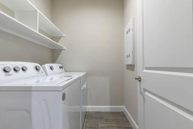 a kitchen with granite countertop stainless steel appliances a refrigerator a sink and cabinets