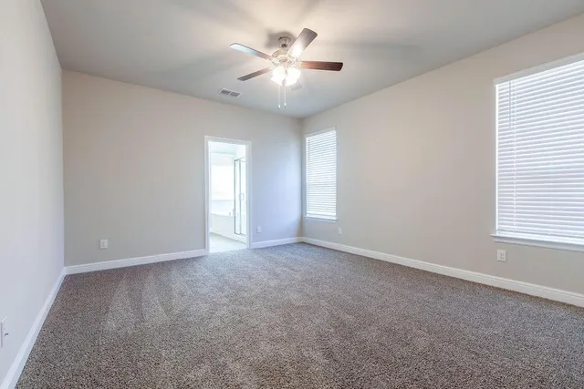 a bedroom with a bed a couch and dresser