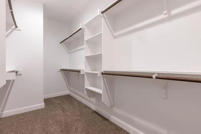 a view of a kitchen with a sink and refrigerator