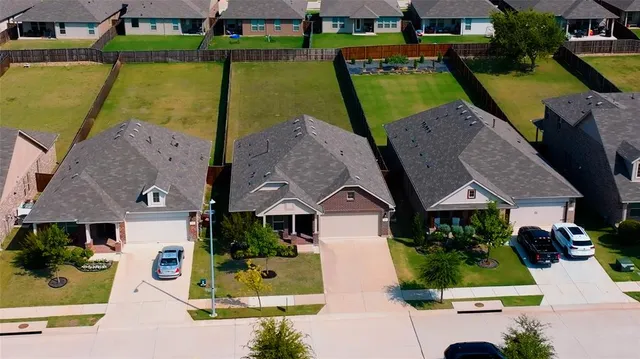 an aerial view of a house with garden space ocean view