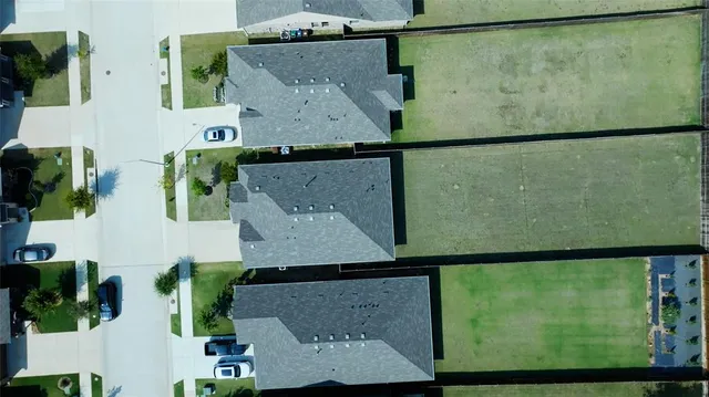 an aerial view of a house with a yard