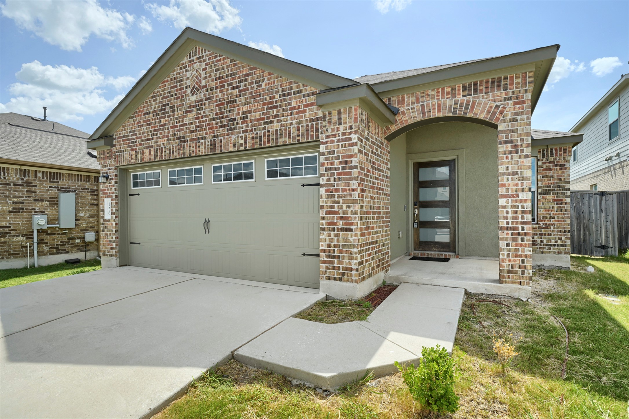 120 Milliner Loop Hutto, TX 78634 - Photo 14 of 15 A well-maintained brick facade and an inviting arched entry welcome you to this charming residence.