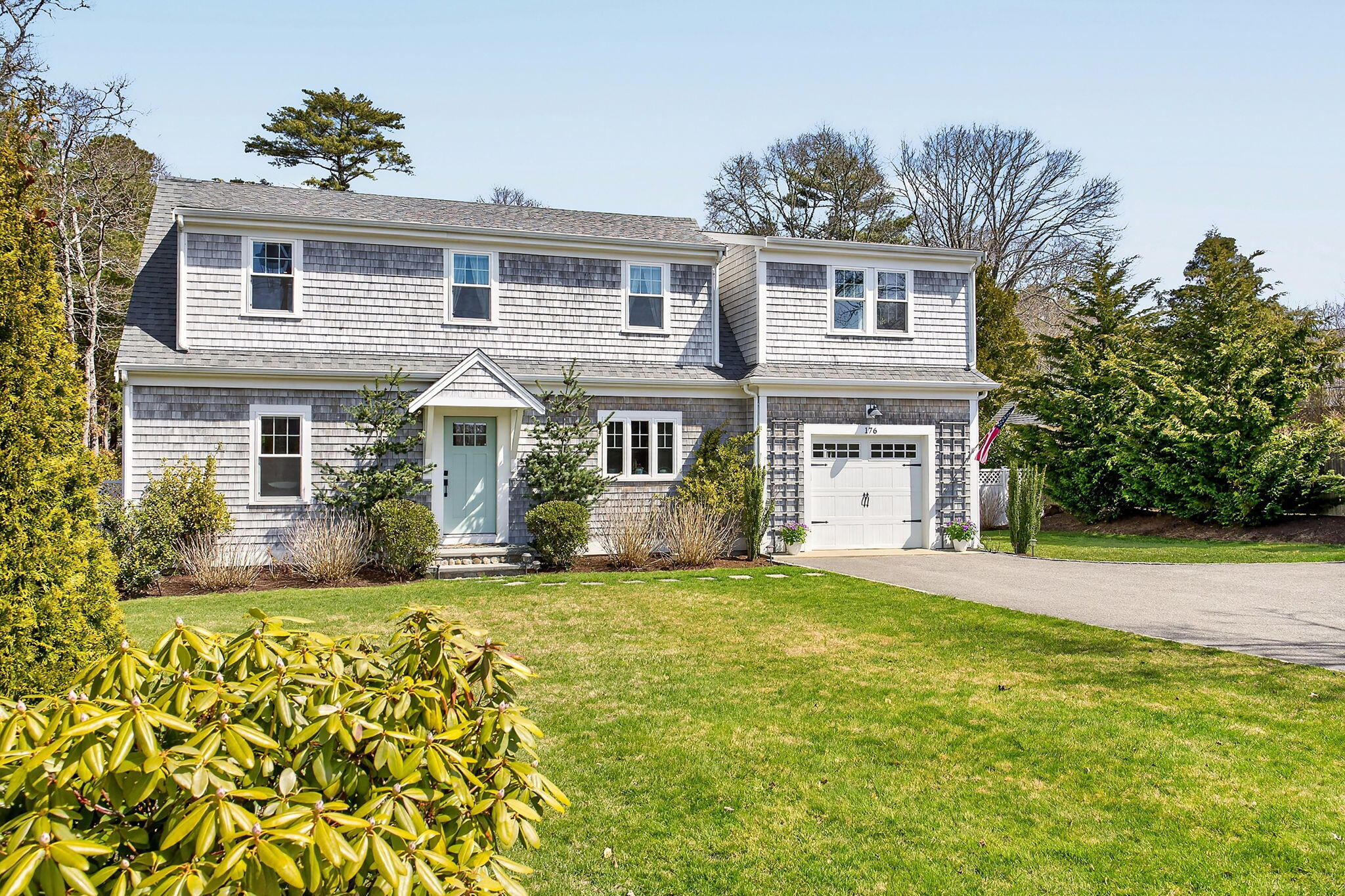 176 Bumps River Road Osterville, MA 02655 - Photo 4 of 54 a front view of a house with a garden and yard