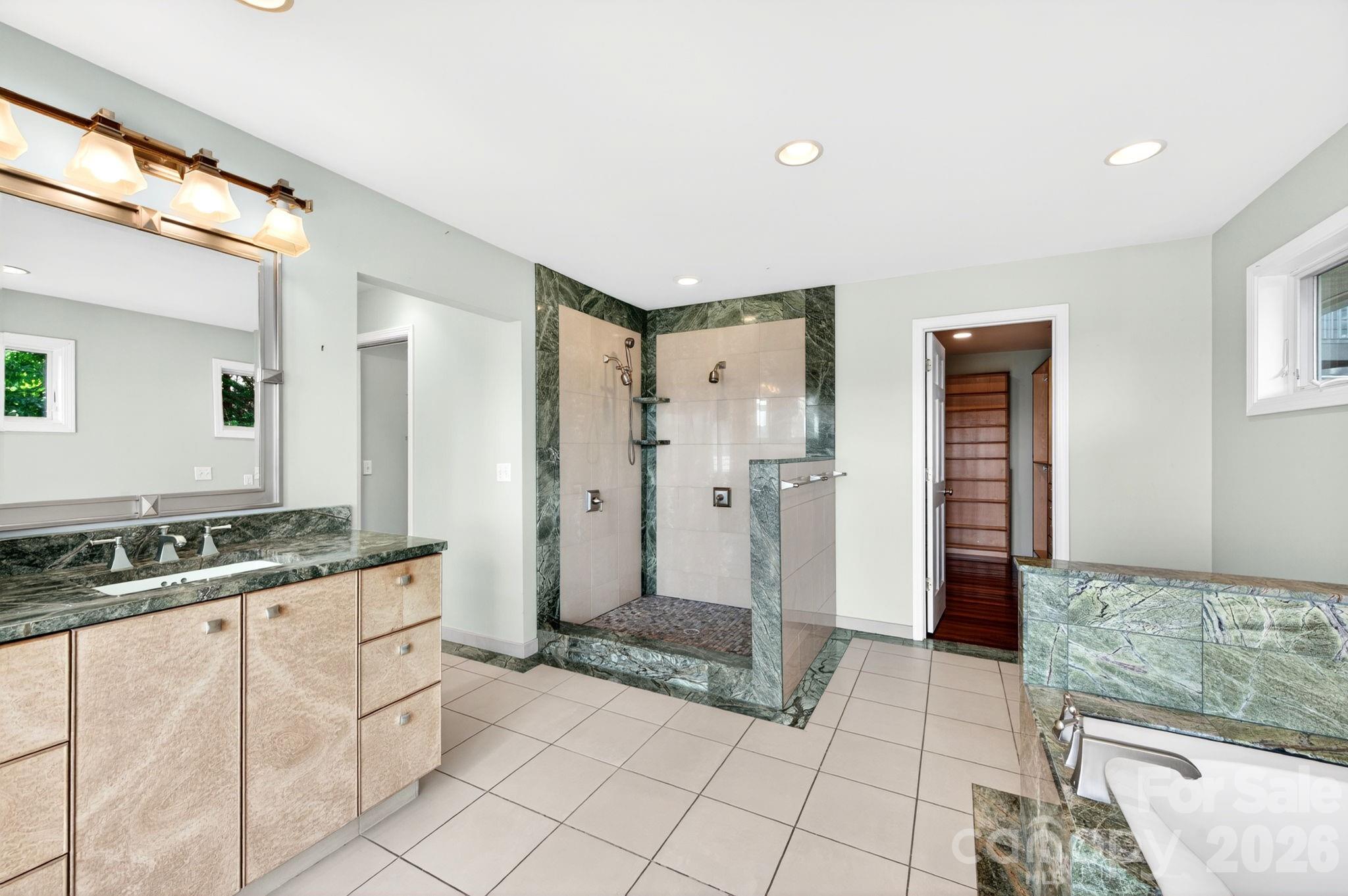 38 Lookout Road Asheville, NC 28804 - Photo 22 of 34 a spacious bathroom with a granite countertop sink and a mirror