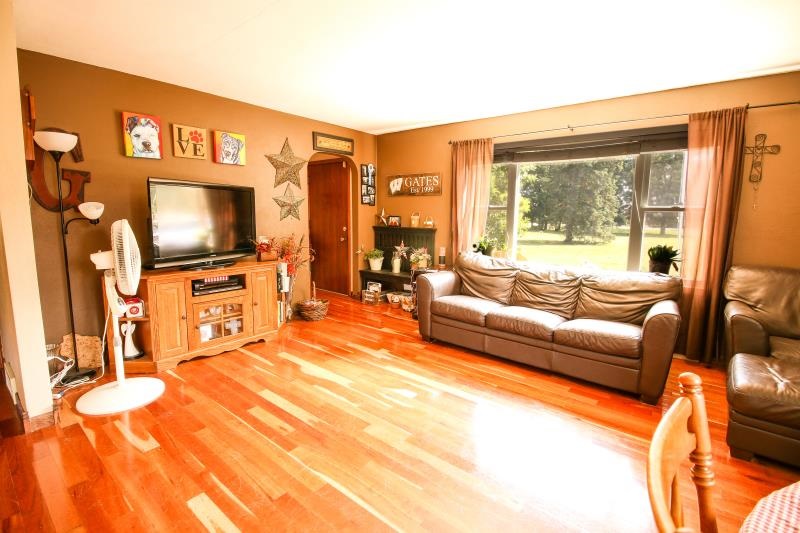 5123 River Road Cherry Valley, IL 61016 - Photo 2 of 15 a living room with furniture and a flat screen tv