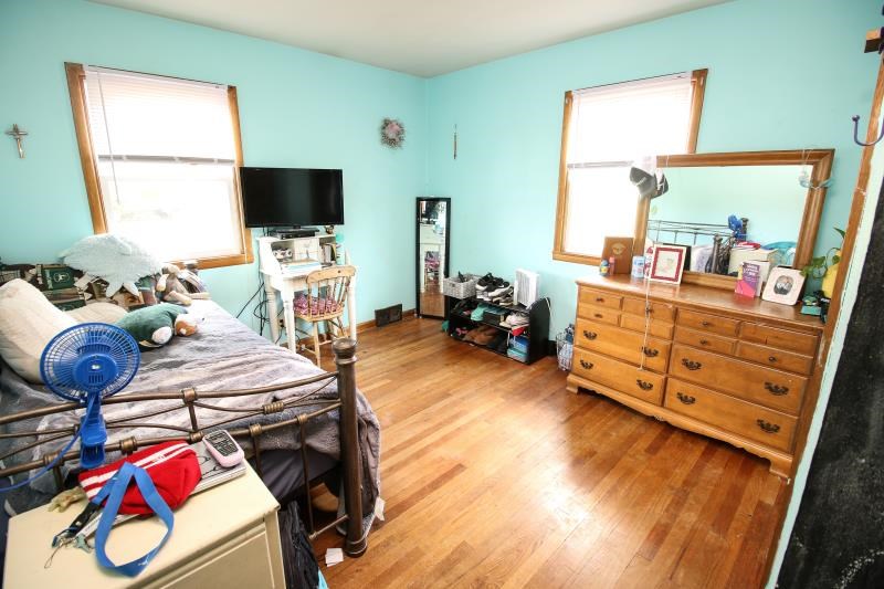 5123 River Road Cherry Valley, IL 61016 - Photo 4 of 15 a bedroom with furniture and a flat screen tv