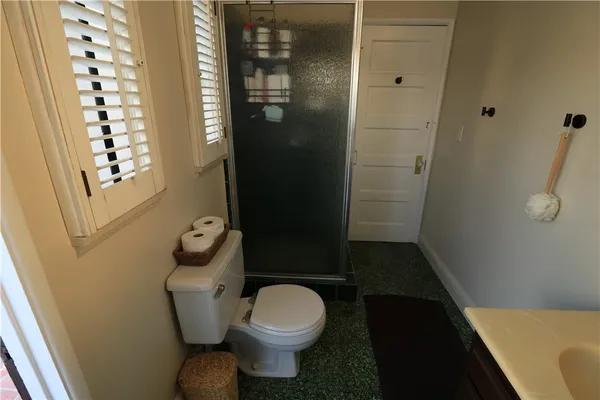 a kitchen with stainless steel appliances a refrigerator a sink a stove and white cabinets