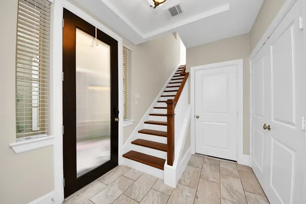 a view of a hallway with windows and stairs