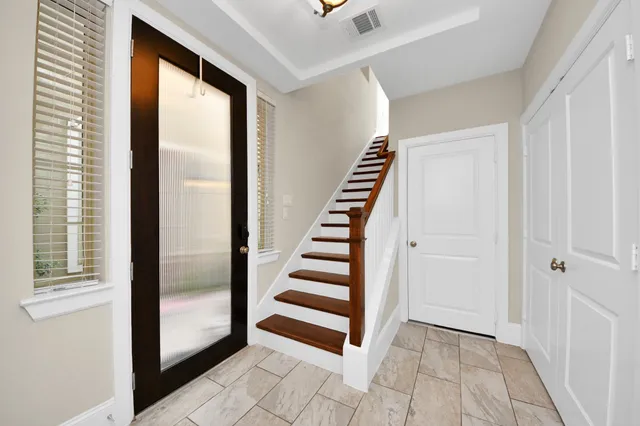 a kitchen with stainless steel appliances granite countertop a sink a stove and a wooden floors
