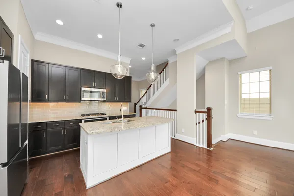 a bathroom with a granite countertop sink and a large mirror