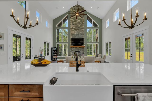 a kitchen with stainless steel appliances a dining table chairs and wooden floor