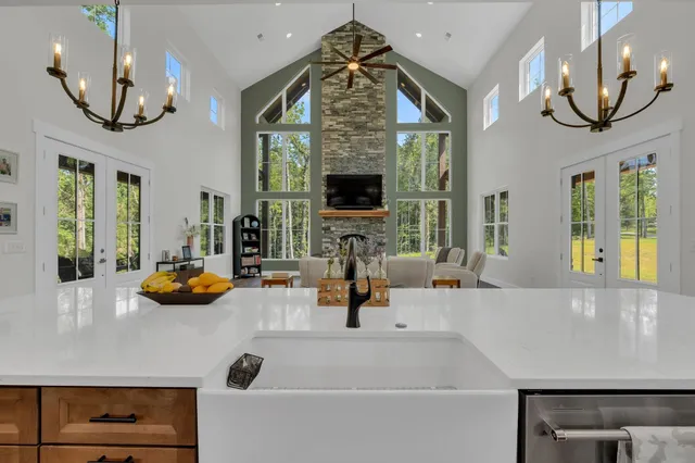 a kitchen with stainless steel appliances a dining table chairs and wooden floor