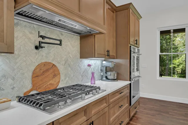 a bedroom with a bed and large windows