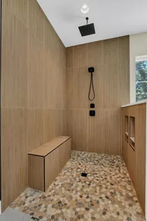 a living room with furniture and a ceiling fan