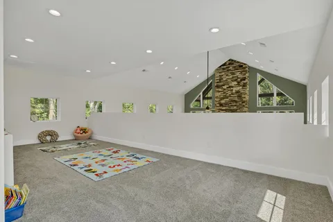 a living room filled with furniture and floor to ceiling windows