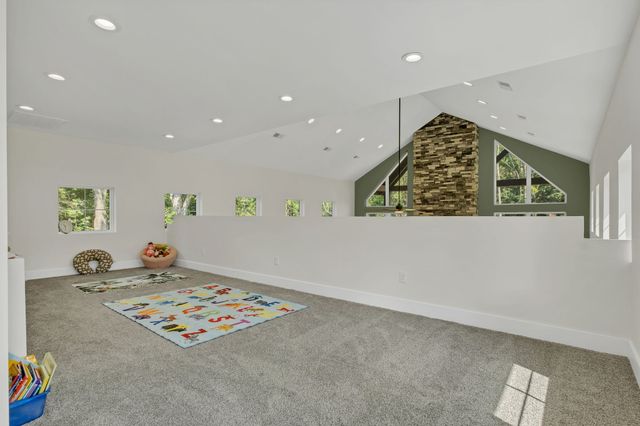 a living room filled with furniture and floor to ceiling windows
