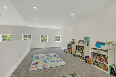 an aerial view of residential house with outdoor space and trees all around