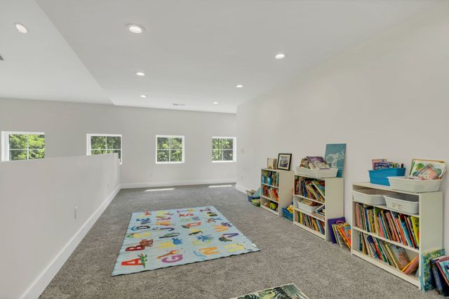 an aerial view of residential house with outdoor space and trees all around