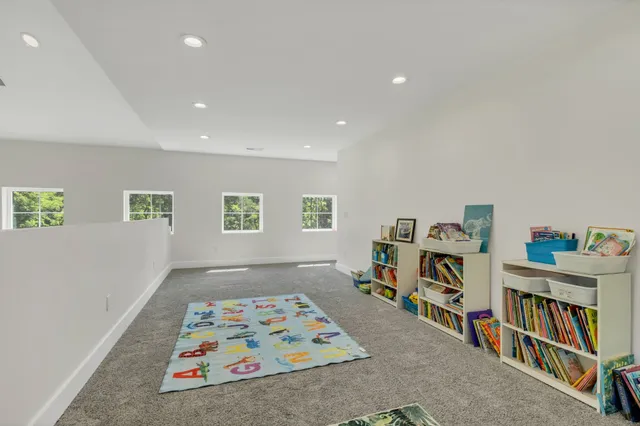 an aerial view of residential house with outdoor space and trees all around