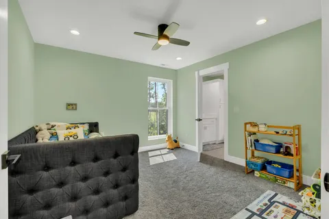 an aerial view of residential house with outdoor space and trees all around