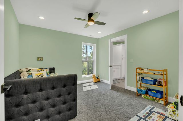 an aerial view of residential house with outdoor space and trees all around