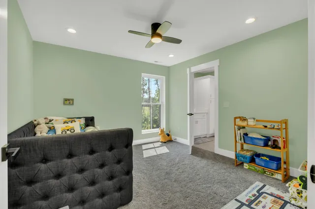 an aerial view of residential house with outdoor space and trees all around