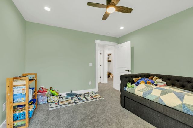 an aerial view of residential houses with outdoor space and trees