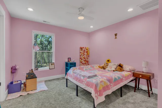 an aerial view of a house with outdoor space and trees all around