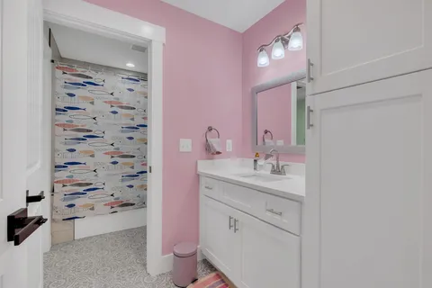 an aerial view of a house with a yard and lake view