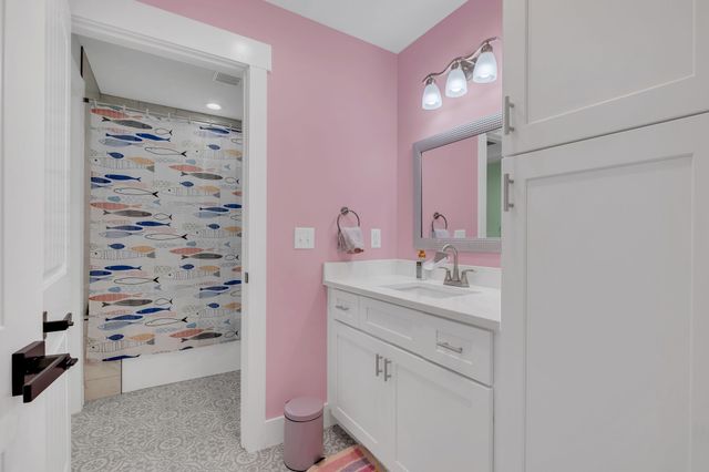 an aerial view of a house with a yard and lake view