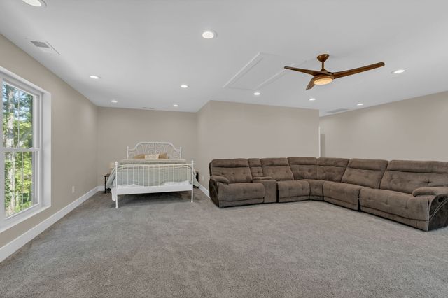 a house view with a tree and wooden fence