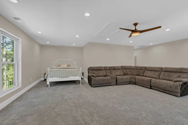 a house view with a tree and wooden fence