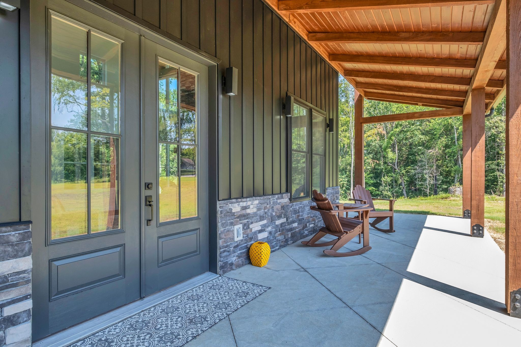 3573 Sandy Springs Road Cedar Hill, TN 37032 - Photo 48 of 87 a living room filled with furniture and floor to ceiling windows