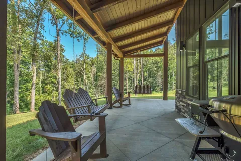 a view of a patio with a table and chairs under an umbrella