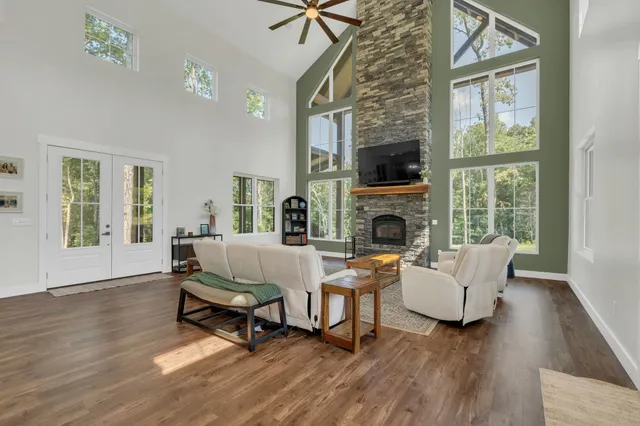 a living room with furniture a flat screen tv and a fireplace