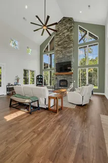 a living room with furniture fireplace and flat screen tv