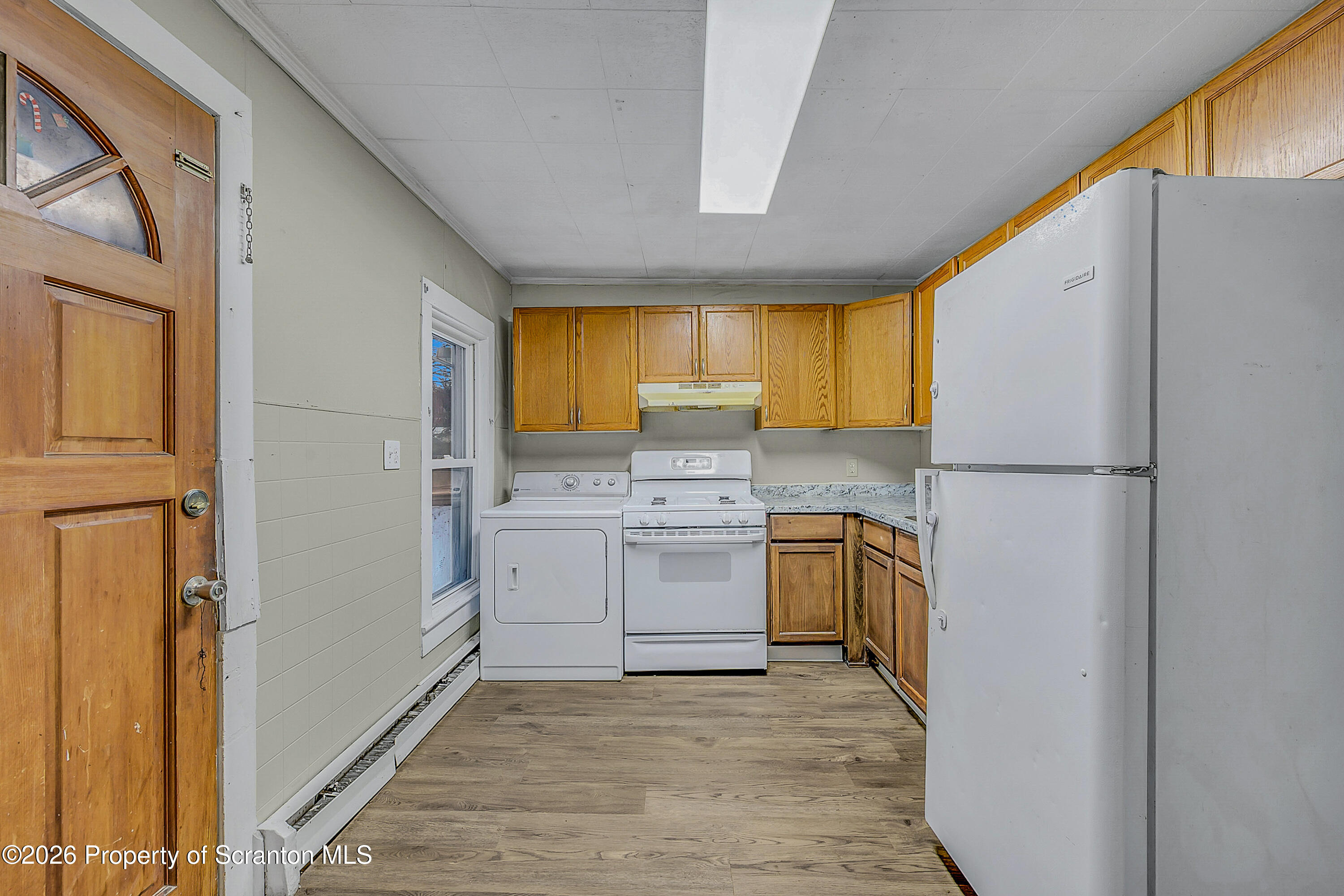 2513 North Main Avenue, Unit 2 Scranton, PA 18508 - Photo 13 of 19 a kitchen with a refrigerator a stove top oven a sink and dishwasher