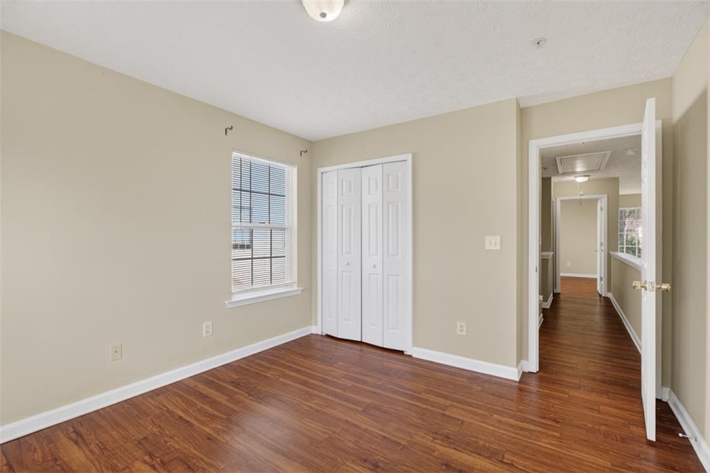 3159 Panthers Trace Decatur, GA 30034 - Photo 18 of 39 a view of an empty room with wooden floor and a window