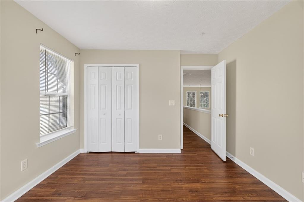 3159 Panthers Trace Decatur, GA 30034 - Photo 19 of 39 a view of an empty room with wooden floor and a window