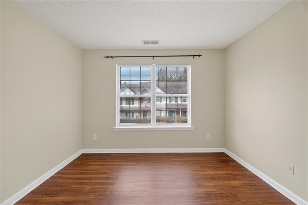 3159 Panthers Trace Decatur, GA 30034 - Photo 21 of 39 an empty room with wooden floor and windows